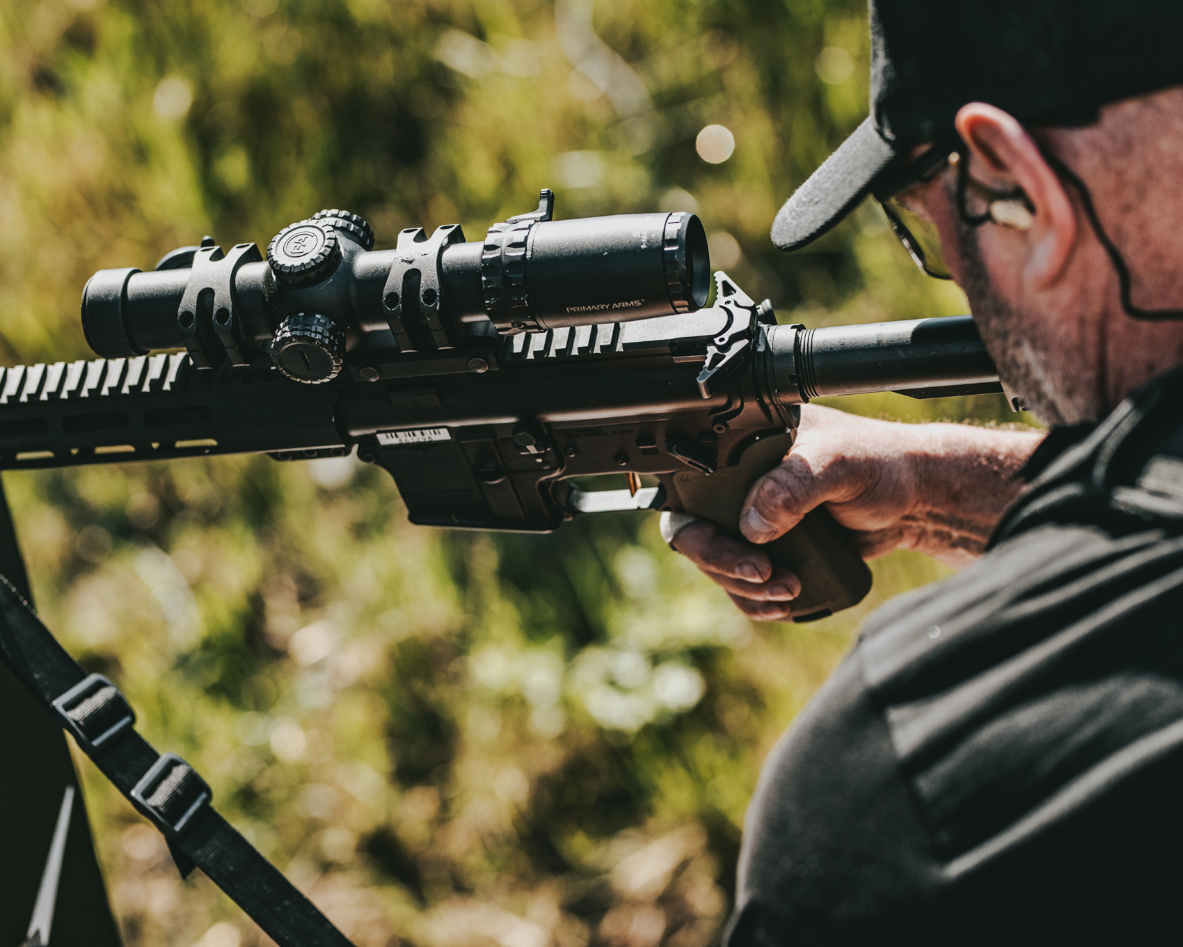 Athlete engaging targets through optic with Mimtac-equipped rifle