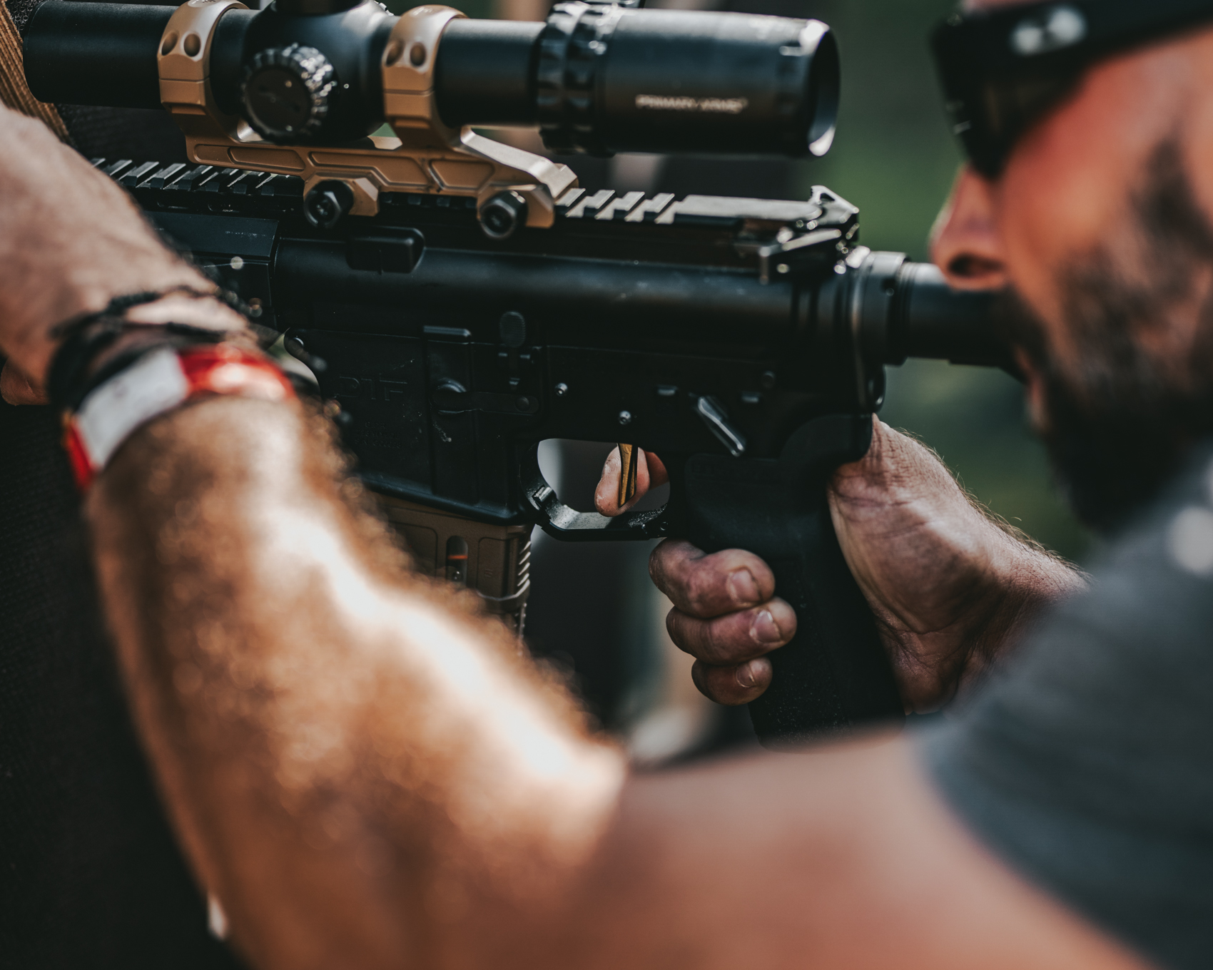 Competitor pressing a Mimtac Match Trigger on an AR15 at TTG Europe Poland Regional